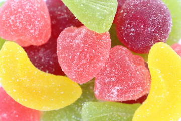 
Multicolored marmalade candy sprinkled with sugar, close-up, background.