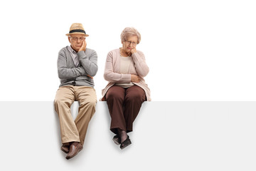 Depressed seniors sitting on a panel