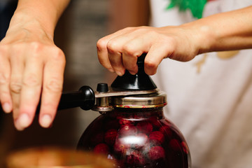 Old machine for rolling metal caps during storage. Preservation of compote from berries