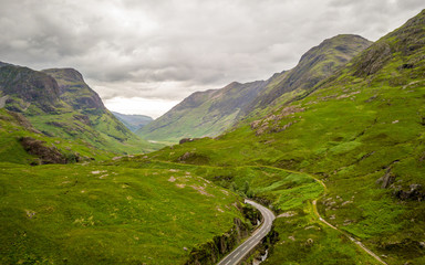 The Highlands, Scotland. Elevated drone image of a road running deep into the Grampian Mountains of the Scottish Highlands.