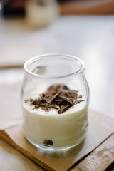 Delicious Italian tiramisu, in the glass, on restaurant table, selective focus