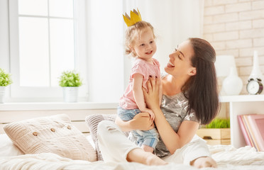 Mother and daughter playing and hugging