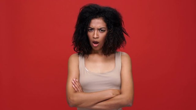 Young Angry African Woman With Arms Crossed Says No Over Red Background