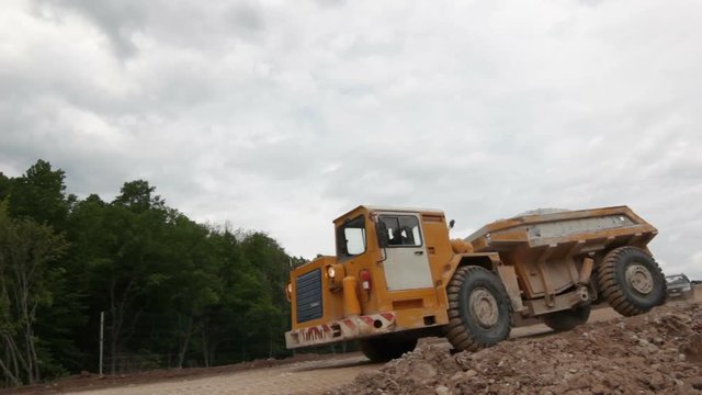 Modern Powerful Dumper with Yellow Cabine Drives against Sky