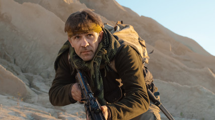 Close-up Shot of Armed Terrorist Sneaking in Desert Environment