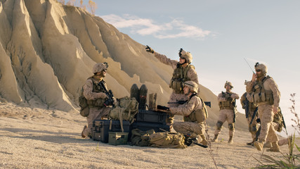 Soldiers are Using Laptop Computer for Surveillance During Military Operation in the Desert.