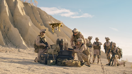 Soldiers are Using Drone And Laptop Computer for Scouting During Military Operation in the Desert.
