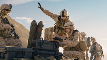 Soldiers are Using Laptop Computer for Surveillance During Military Operation in the Desert.