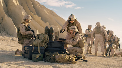 Soldiers are Using Laptop Computer for Surveillance During Military Operation in the Desert.