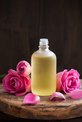 Fototapeta na wymiar Essential oil and rose flowers aromatherapy spa perfumery