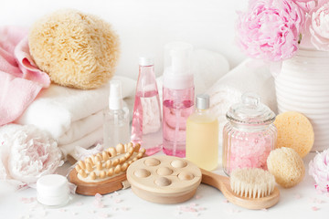 Fototapeta na wymiar bath and spa with peony flowers beauty products brush towels