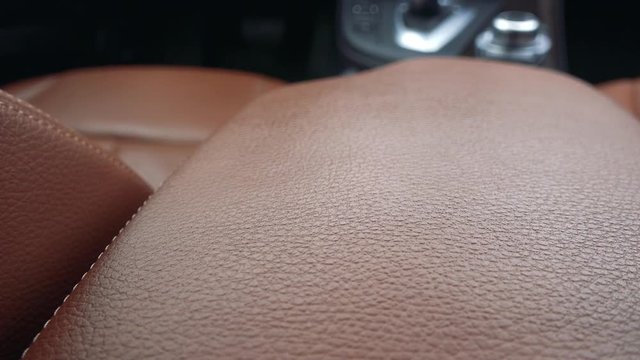 Closeup on a luxurious brown leather car seat cover
