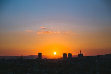 Sun setting over city
