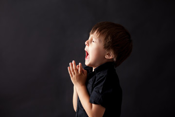 Little boy praying, child praying, isolated background
