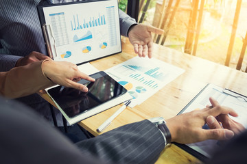 Team work process. young business managers crew working with new startup project. labtop on wood table, typing keyboard, texting message, analyze graph plans