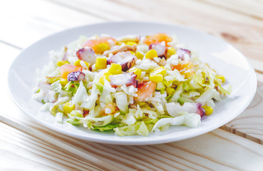 Cold summer salad with rice, coctopus, corn and vegetables. Concept of healthy food.