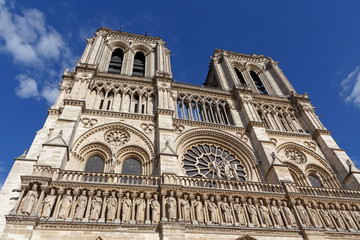 Fototapeta na wymiar close up of Notre-Dame de Paris cathedral against blue sky