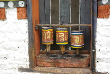 Prayer wheels decorating the side of a monastery in Bhutan