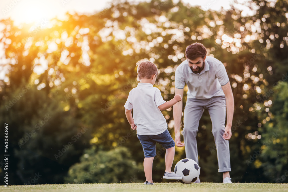 Wall mural dad with son playing football