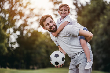 Dad with son playing football