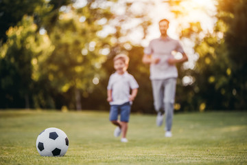 Dad with son playing football