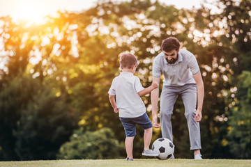 Dad with son playing football