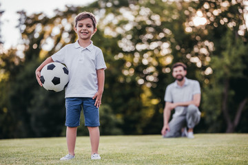 Dad with son playing football