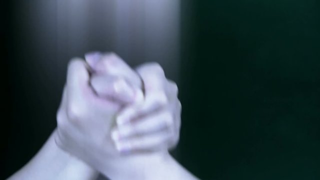Two people in hand wrestling game.