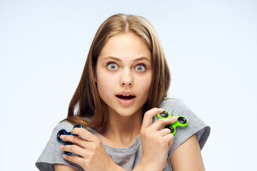 Beautiful young woman on white isolated background holds a spinner