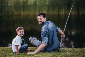 Dad and son are fishing