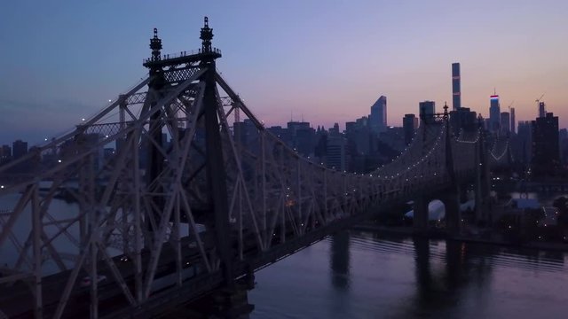 lighter dusk flying alongside Queensboro Bridge towards Manhattan