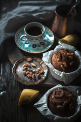 Flavored banana cupcakes on the wooden table vertical