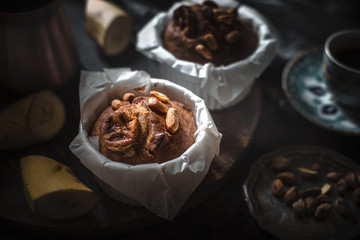 Banana cupcakes with nuts on the wooden table horizontal