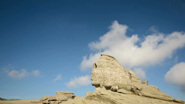 Dynamic white clouds over The Sphinx, an impressive natural rock formation from Bucegi Mountains., Romania.  4k timelapse.