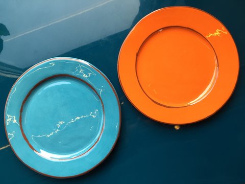 Two Empty Ceramic Plates Stand On The Table.