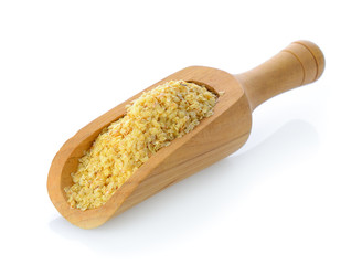 Wheat germ in wood scoop on white background