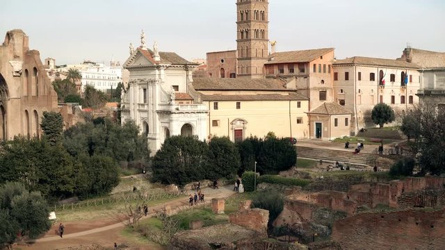 Panorama of the Rome, Italy city view with its ruins, columns, palaces and an impressive Arch of Titus and Colosseum.