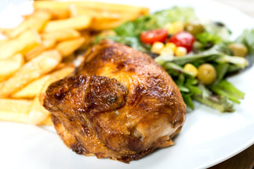 Chicken skewers with sauce and golden French fries potatoes