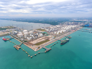 Fototapeta na wymiar Aerial view Oil refinery with a background of the sea and sky.The factory is located in the middle of nature and no emissions. The area around the air pure.business logistic.