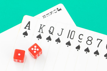 Dices and cards on green casino table