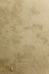 Old yellow dirty grunge wall background with empty space