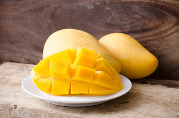 Ripe mango fruit on white dish ready to eating