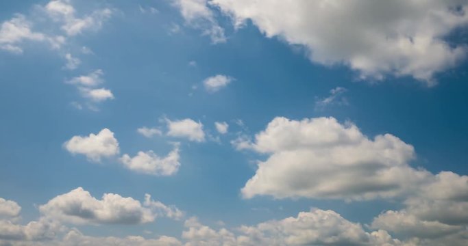 Time lapse clip of white fluffy curly rolling clouds