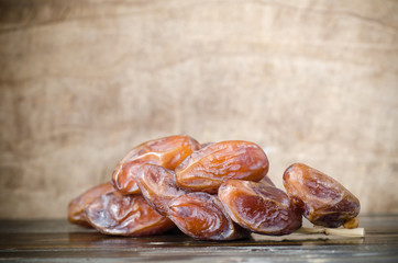 Dried date palm fruit (Deglet Noor) on wooden background,Ramadan fruit