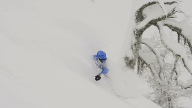 snowboarder Freerider rides in the forest