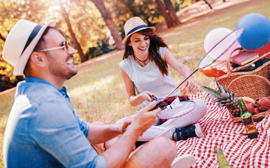 Couple enjoying picnic together. Love and tenderness, dating, romance, lifestyle concept