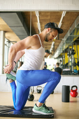 Obraz premium Young man workout in healthy club. Man working exercise