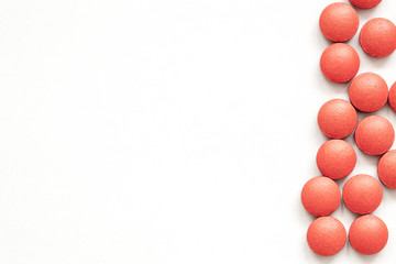Red pills on white background
