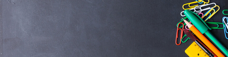 Colorful stationery back to school concept on blackboard background