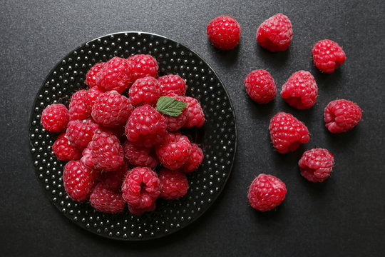 juicy raspberries on a black background